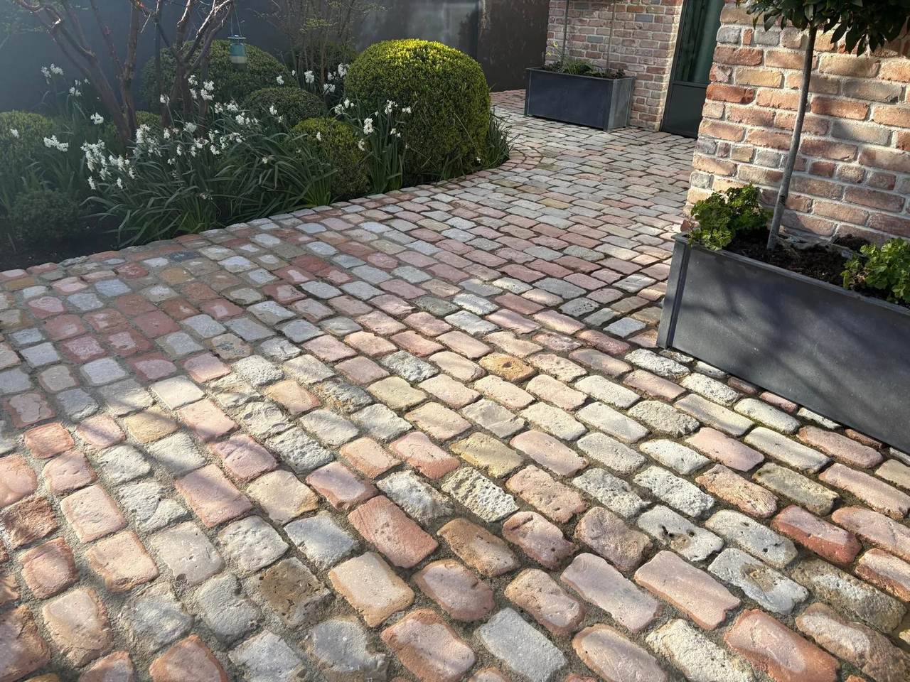 Curved cobble path cleaned back to its original colours